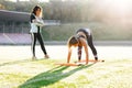 Young girl doing exercises under physiotherapist supervision. Patient Uses Physical Therapy to Recover from Surgery and