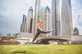 Young girl doing stretching against skyscrapers Royalty Free Stock Photo