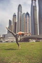 Young girl doing stretching against skyscrapers Royalty Free Stock Photo