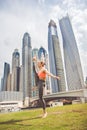 Young girl doing stretching against skyscrapers Royalty Free Stock Photo