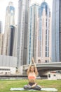 Young girl doing yoga against skyscrapers Royalty Free Stock Photo