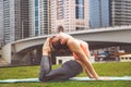 Young girl doing yoga against skyscrapers Royalty Free Stock Photo