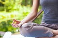 Young girl doing yoga (lotus pose) in the park Royalty Free Stock Photo