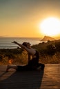 Young girl doing yoga at sunset. Doing yoga outdoors against the sun. Royalty Free Stock Photo