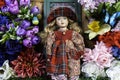 Young girl doll in elaborate dress and spring flowers