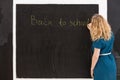 Young girl drawing on a black background. Teacher hand writting on chalkboard Back to school. Education and idea concept Royalty Free Stock Photo