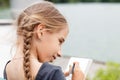 Young girl drawing sketch in notebook near pond Royalty Free Stock Photo