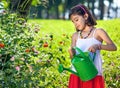 Young Girl in Dress Watering Plants.