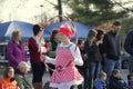 Young girl dressed as a candy cane and performing with hula hoop in annual Holiday Parade, Glens Falls, New York, 2014