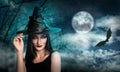 Young girl dressed as witch in misty forest on full moon night. Halloween fantasy