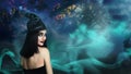 Young girl dressed as witch in misty forest at night. Halloween fantasy Royalty Free Stock Photo