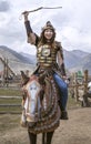 Young girl dressed like a mongol warrior on ahorse