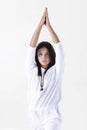 Young girl dressed in white doing yoga over white background. .Urdvha hastasana yoga pose