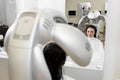 Young girl dries her hair in a hairdresser with a professional hair dryer. Royalty Free Stock Photo