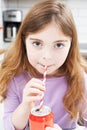 Young Girl Drinking Can Of Soda Through Straw Royalty Free Stock Photo