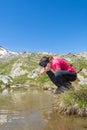 Young girl drinking clean lake water Royalty Free Stock Photo