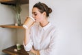 Young girl drinking coffee in the cafe.