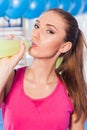 Young girl drinking isotonic drink, gym. Full of positive emotion. Royalty Free Stock Photo