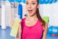 Young girl drinking isotonic drink, gym. She is happy and full o Royalty Free Stock Photo