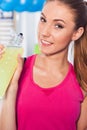 Young girl drinking isotonic drink, gym. She is happy and full o Royalty Free Stock Photo