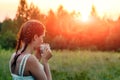 A young girl drinks coffee and looks into the distance to the sunset, waiting for someone. The concept of expectation, longing,