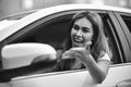 Young girl driving a car shocked about to have traffic accident, windshield view. Royalty Free Stock Photo