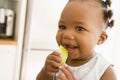 Young girl eating apple indoors Royalty Free Stock Photo