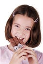 Young girl eating bar of chocolate
