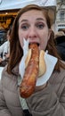 Girl eating a bratwurst sausage Royalty Free Stock Photo
