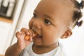 Young girl eating carrot indoors Royalty Free Stock Photo