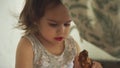 Young girl eating chicken leg