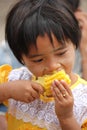 Young girl eating cob