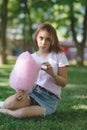 Young girl eating cotton candy in the park Royalty Free Stock Photo