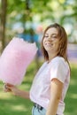 Young girl eating cotton candy in the park Royalty Free Stock Photo