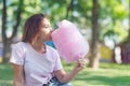 Young girl eating cotton candy in the park Royalty Free Stock Photo