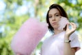 Young girl eating cotton candy in the park Royalty Free Stock Photo