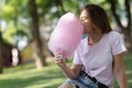 Young girl eating cotton candy in the park Royalty Free Stock Photo