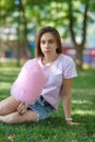 Young girl eating cotton candy in the park Royalty Free Stock Photo