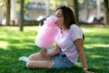 Young girl eating cotton candy in the park Royalty Free Stock Photo