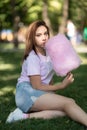 Young girl eating cotton candy in the park Royalty Free Stock Photo