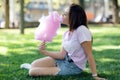 Young girl eating cotton candy in the park Royalty Free Stock Photo