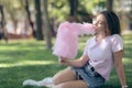 Young girl eating cotton candy in the park Royalty Free Stock Photo