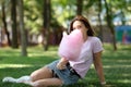 Young girl eating cotton candy in the park Royalty Free Stock Photo