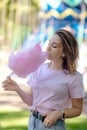 Young girl eating cotton candy in the park Royalty Free Stock Photo