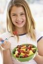 Young Girl Eating Fresh Fruit Salad Royalty Free Stock Photo