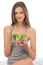 Young girl eating fresh salad