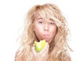 Young girl eating green apple on white background. Royalty Free Stock Photo