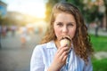 Young girl eating ice cream in the city street. Royalty Free Stock Photo