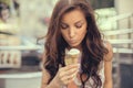 Young girl eating ice cream in the city street Royalty Free Stock Photo