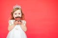 Young girl eating mini birthday cake over red background Royalty Free Stock Photo